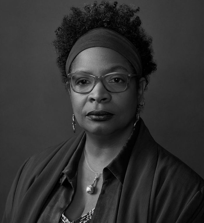 Portrait en noir et blanc d'une femme noire aux cheveux courts et regard intense